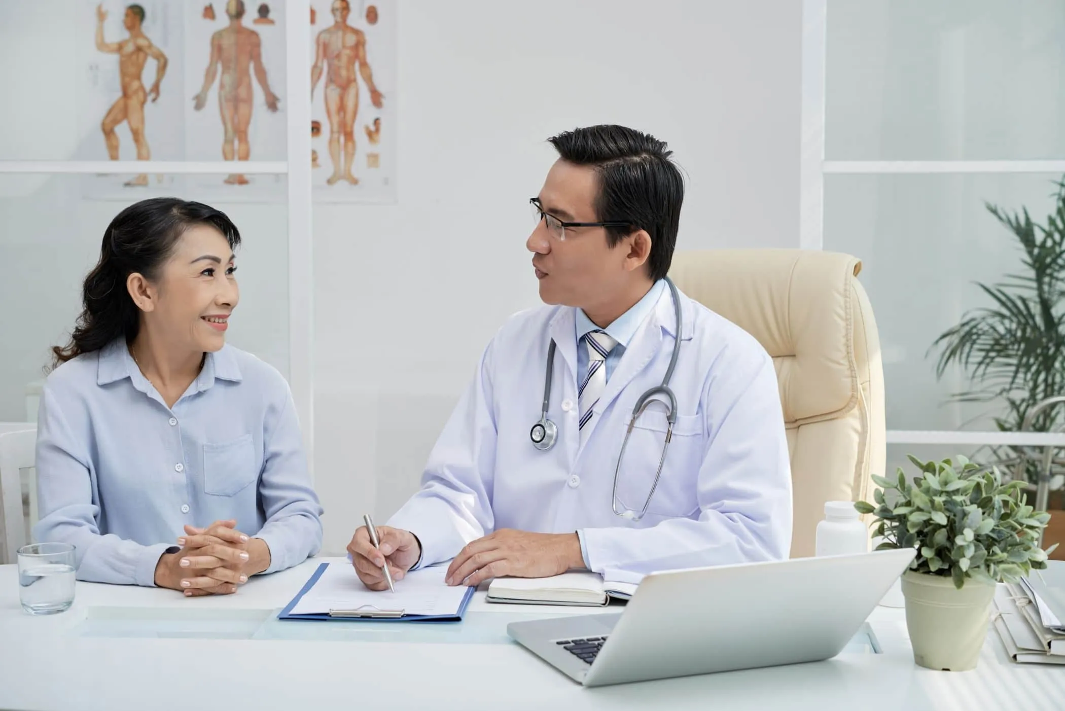 A doctor and a patient talking across a desk