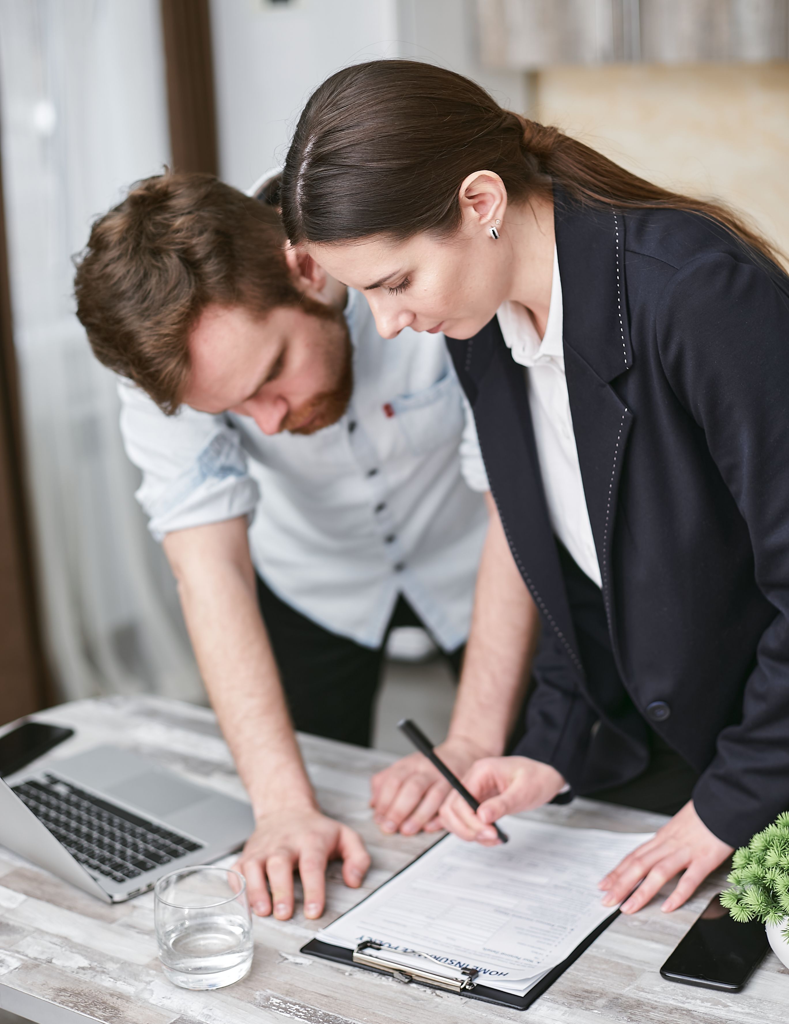 Two colleagues reviewing documents together