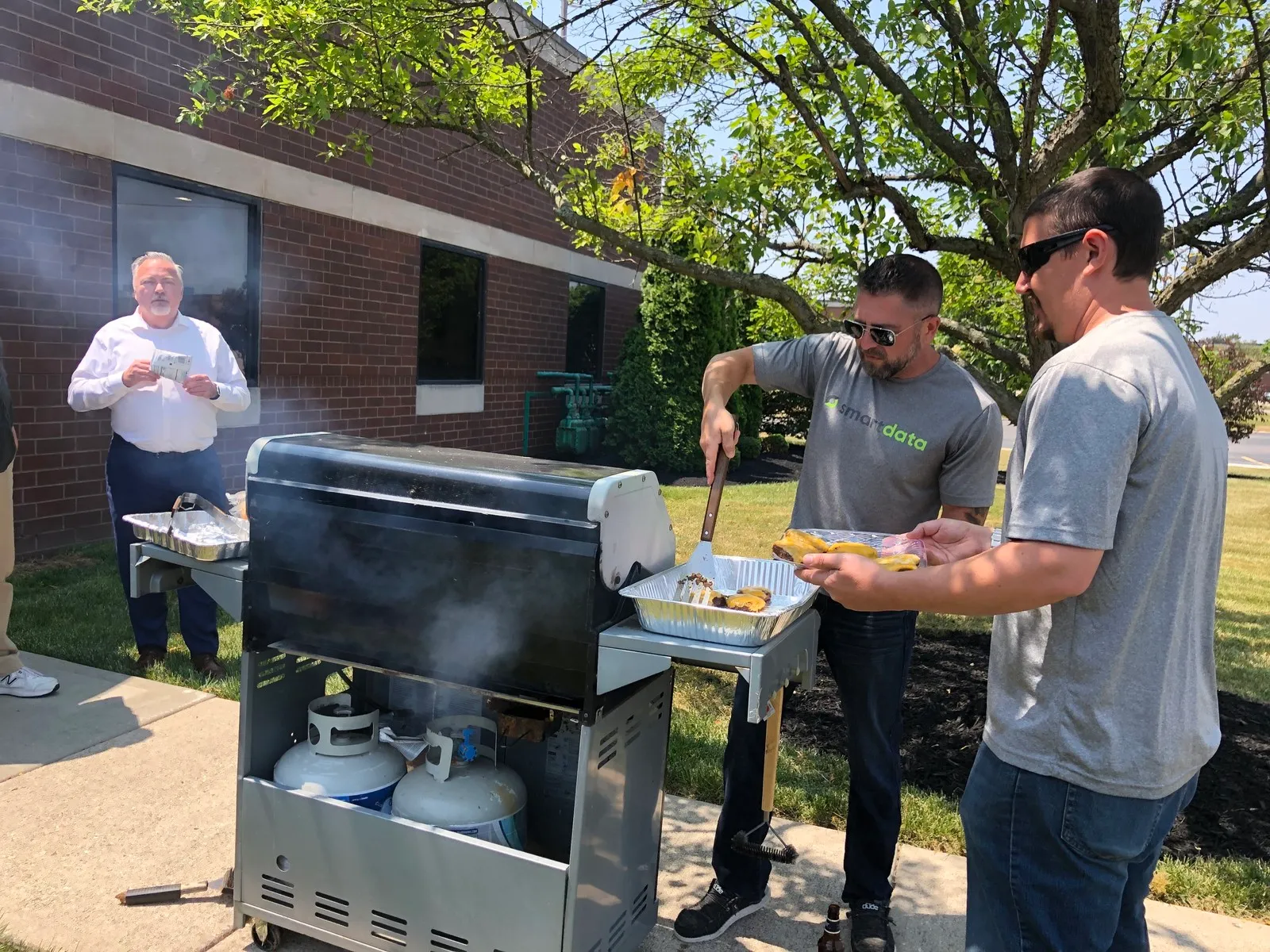 Team members grilling at a company cookout