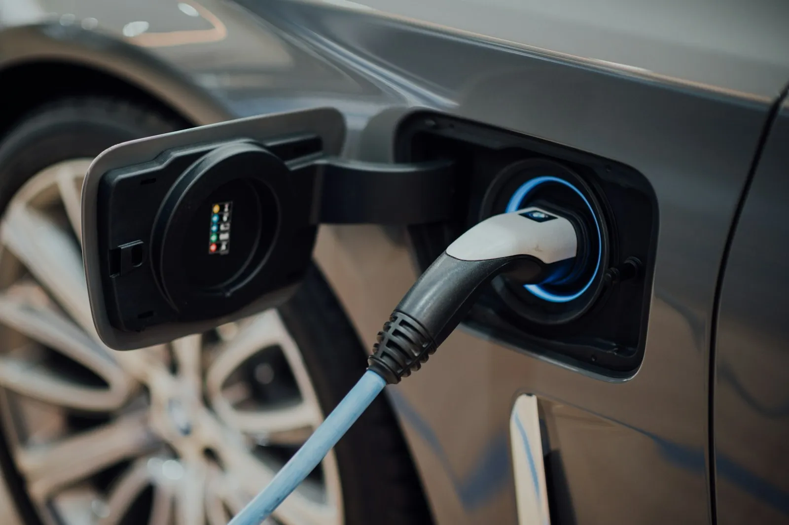 A charging cable plugged into an electric car's charging port