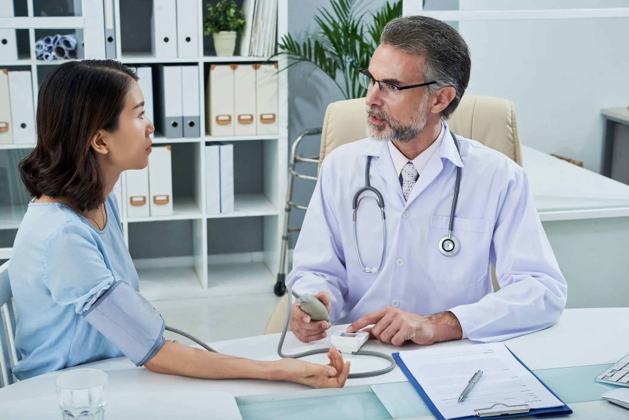 A doctor consulting a patient at a desk