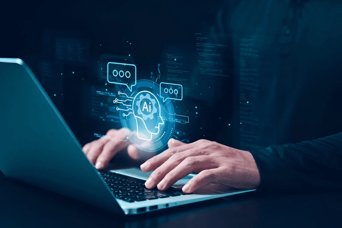 Hands on a laptop keyboard under a glowing AI graphic