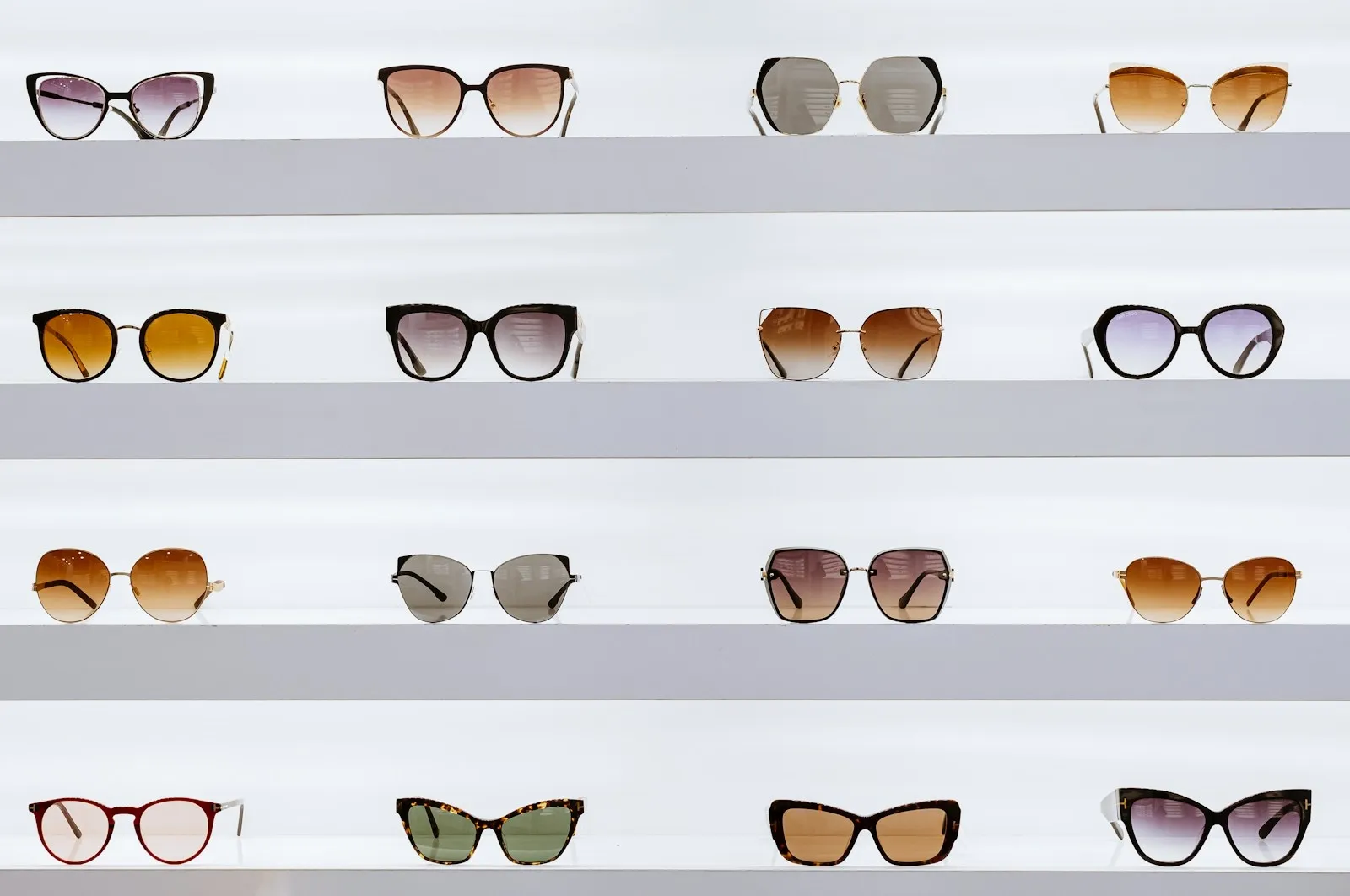 Rows of sunglasses on retail display shelves