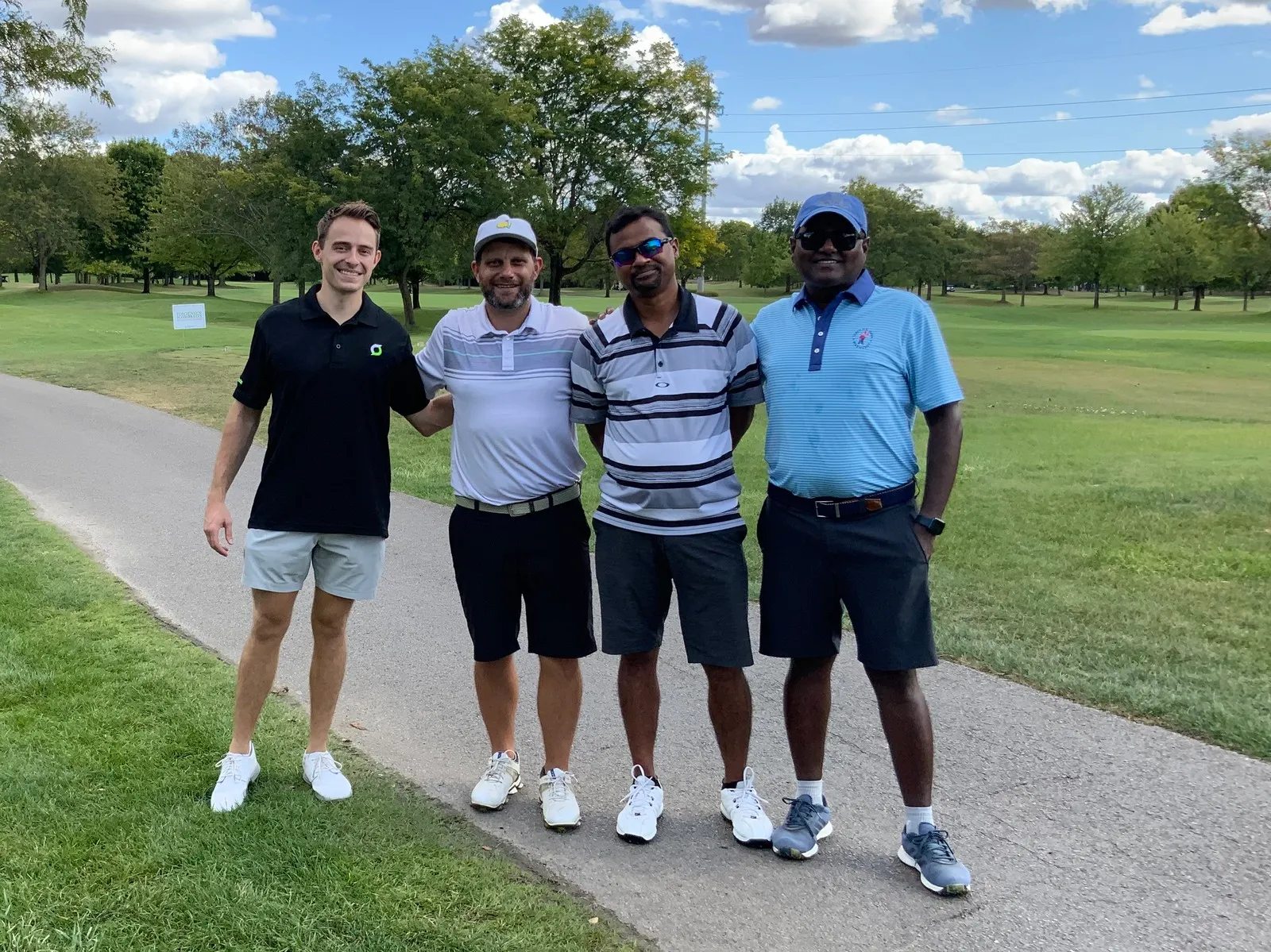 Four team members on a golf course