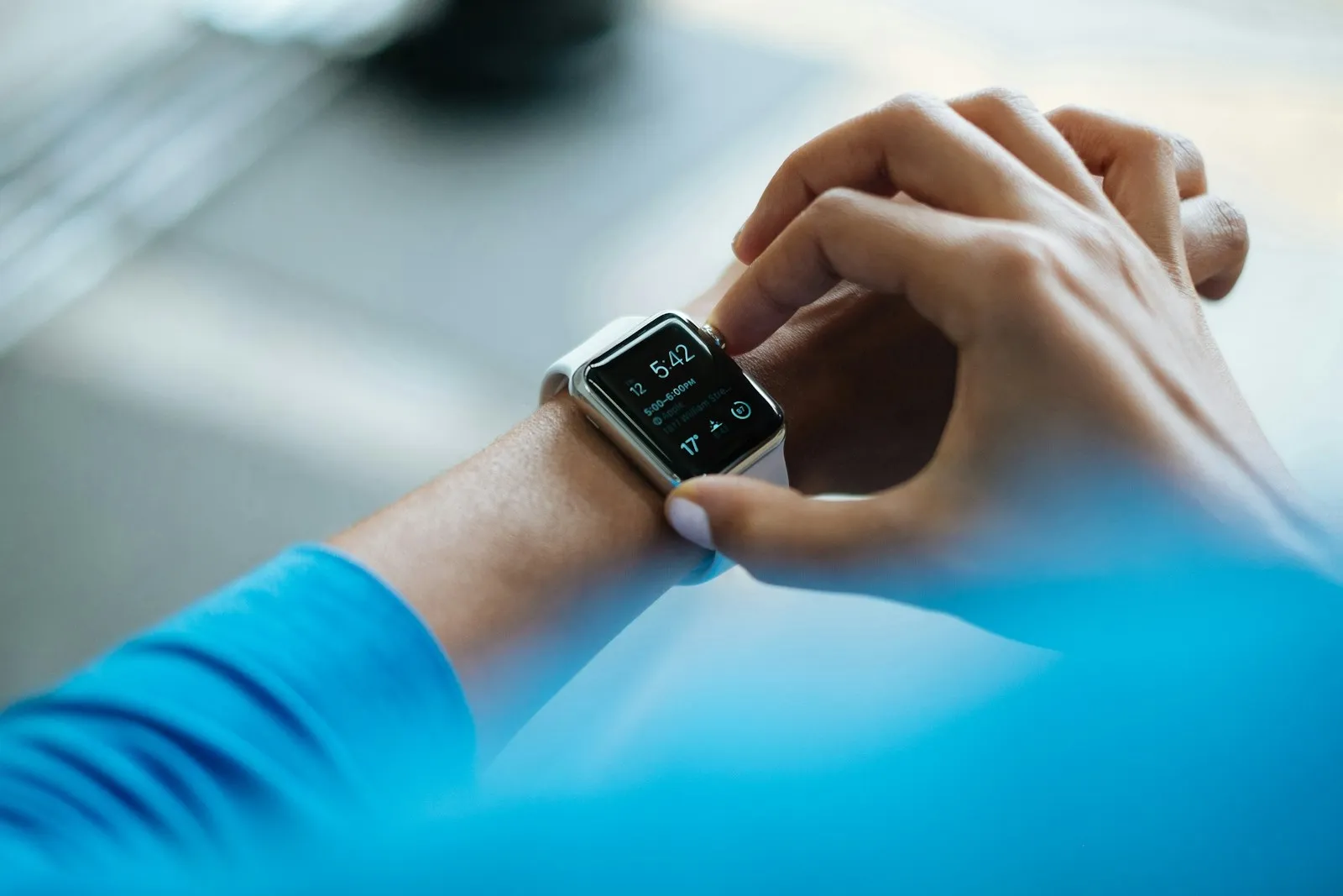 A person checking a smartwatch on their wrist