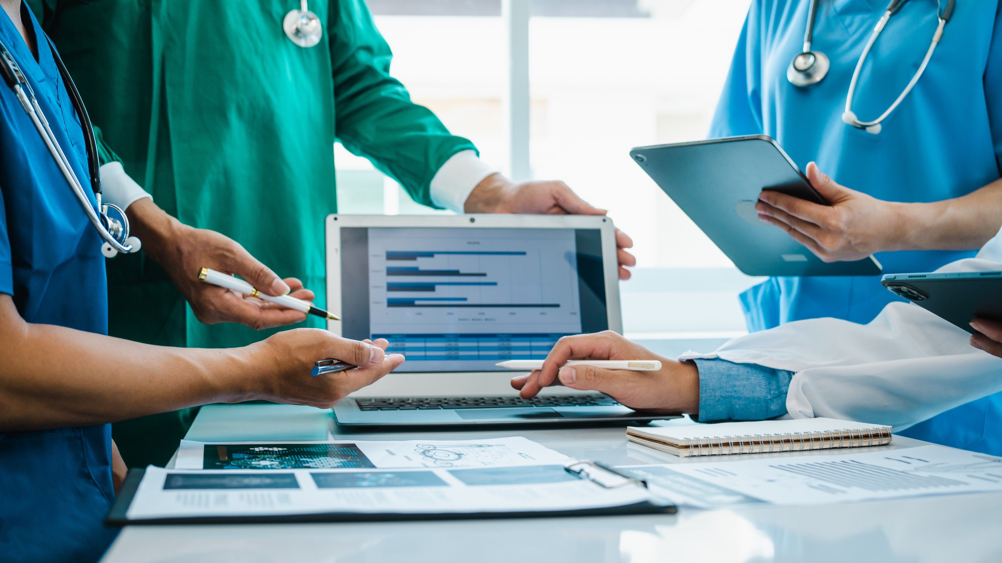 A clinical team gathered round a laptop