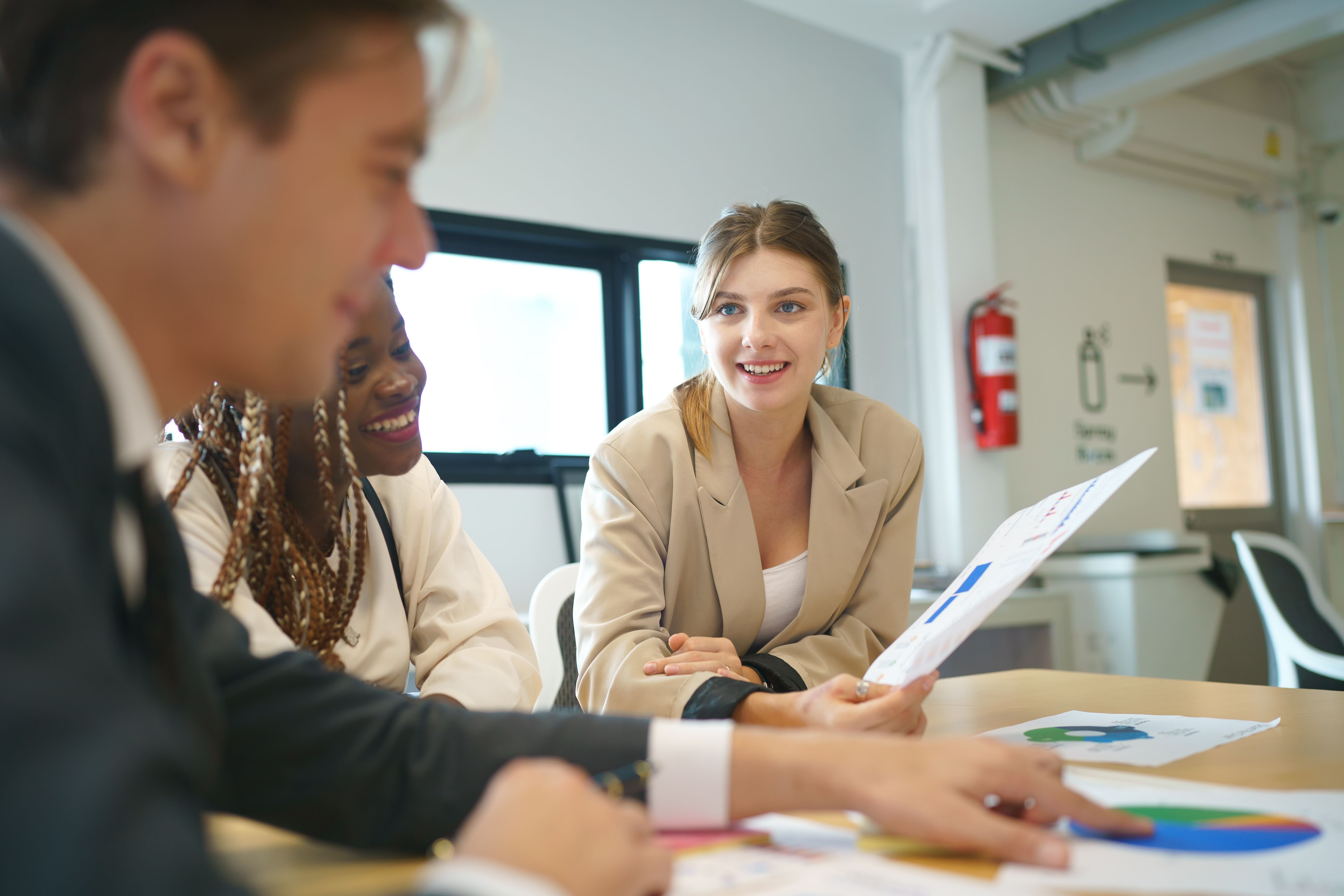 Colleagues reviewing figures in a meeting