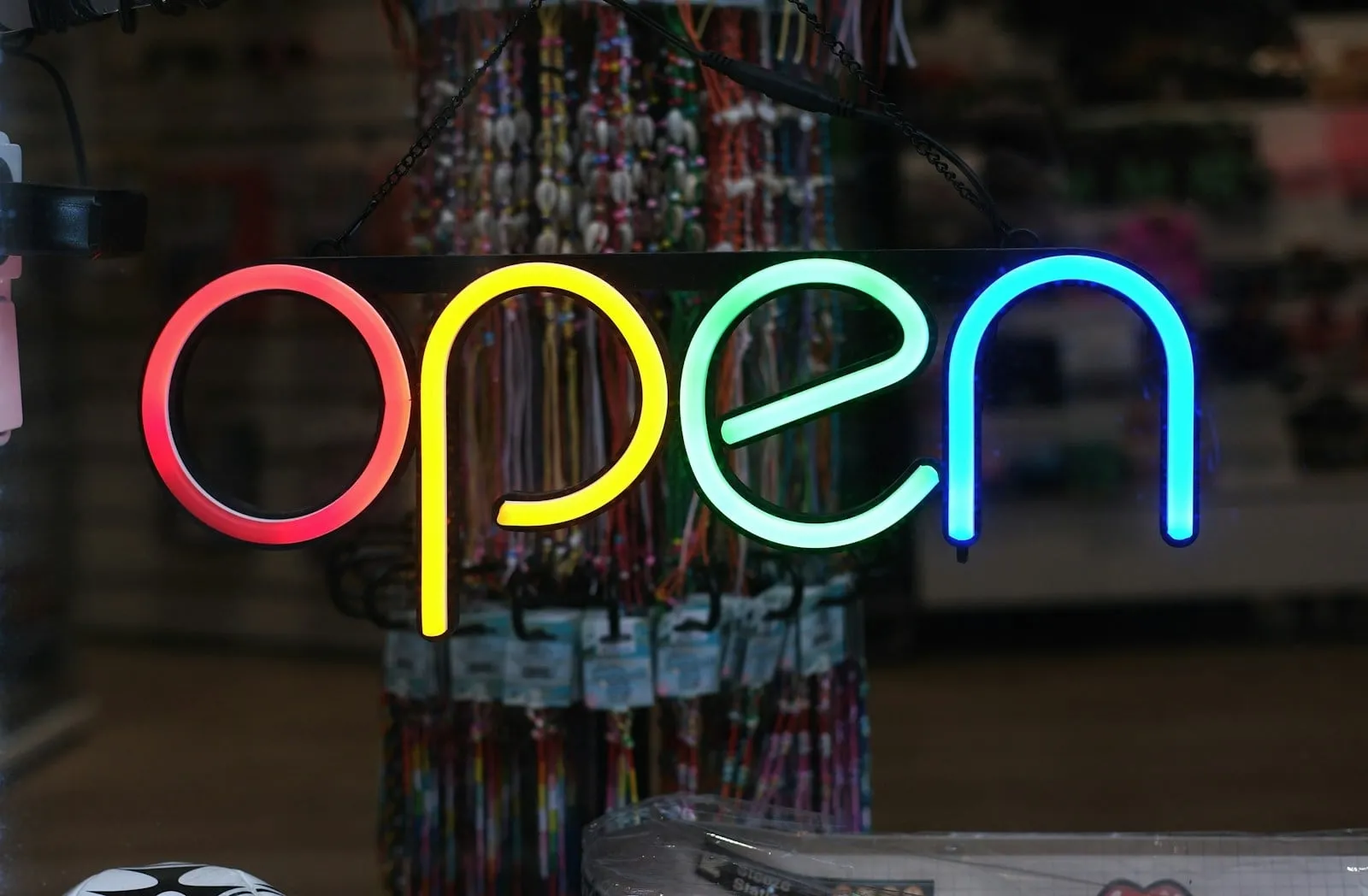 A neon OPEN sign in a shop window