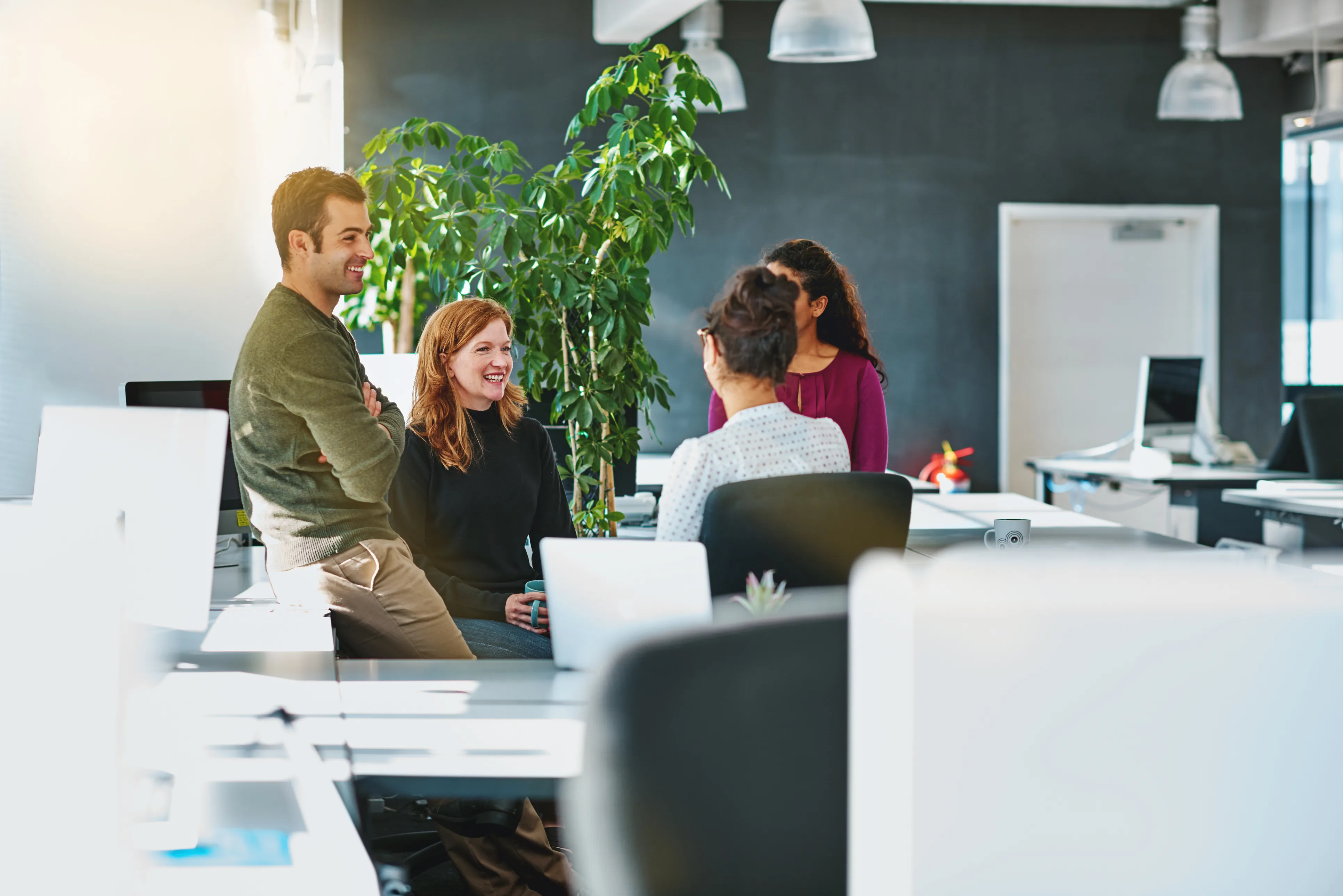 Colleagues collaborating at a shared desk