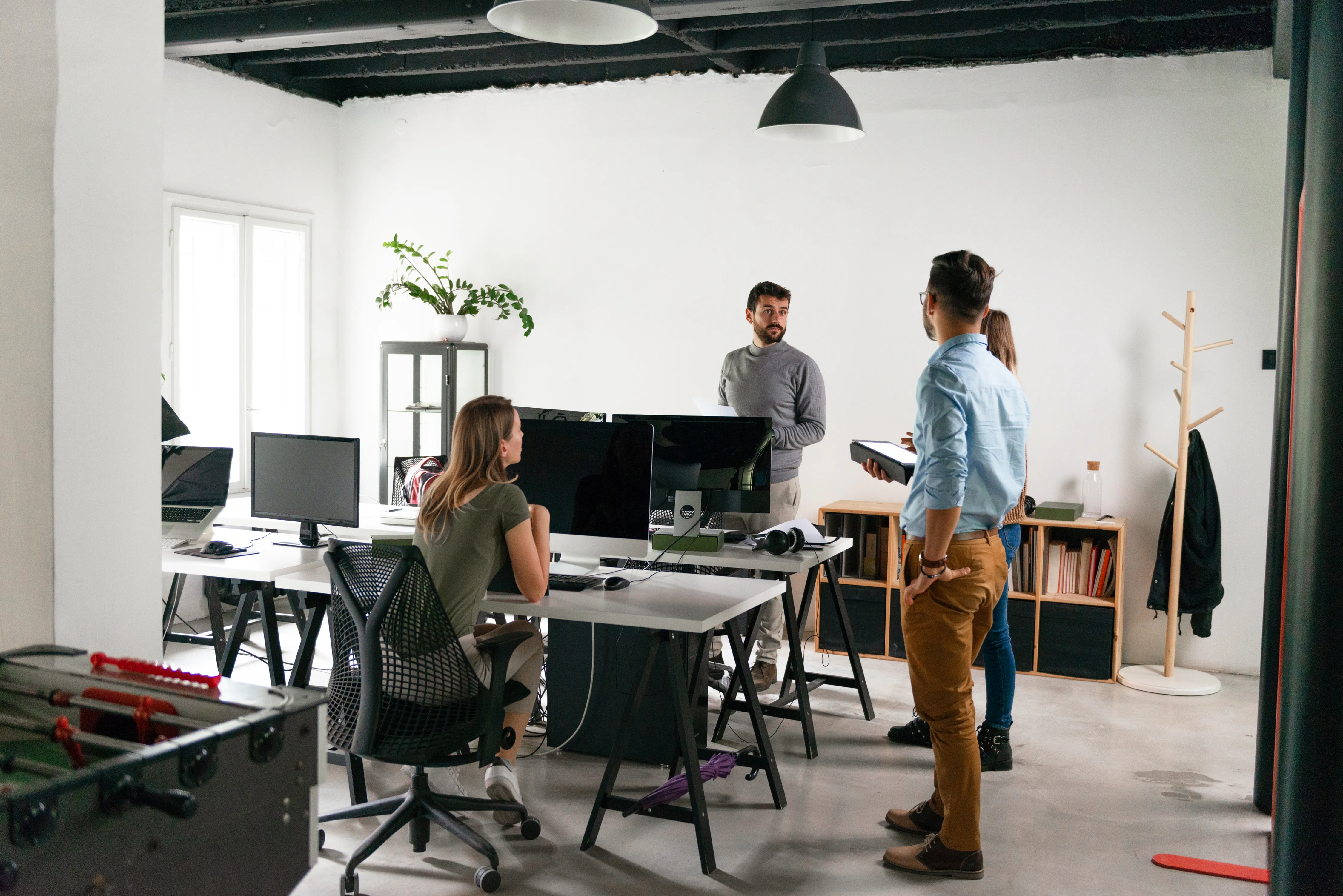 Colleagues meeting on an open office floor