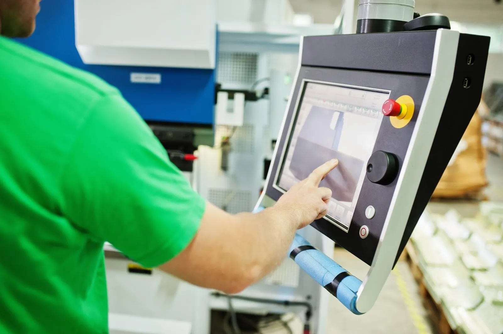 An operator using the touchscreen on a packaging machine
