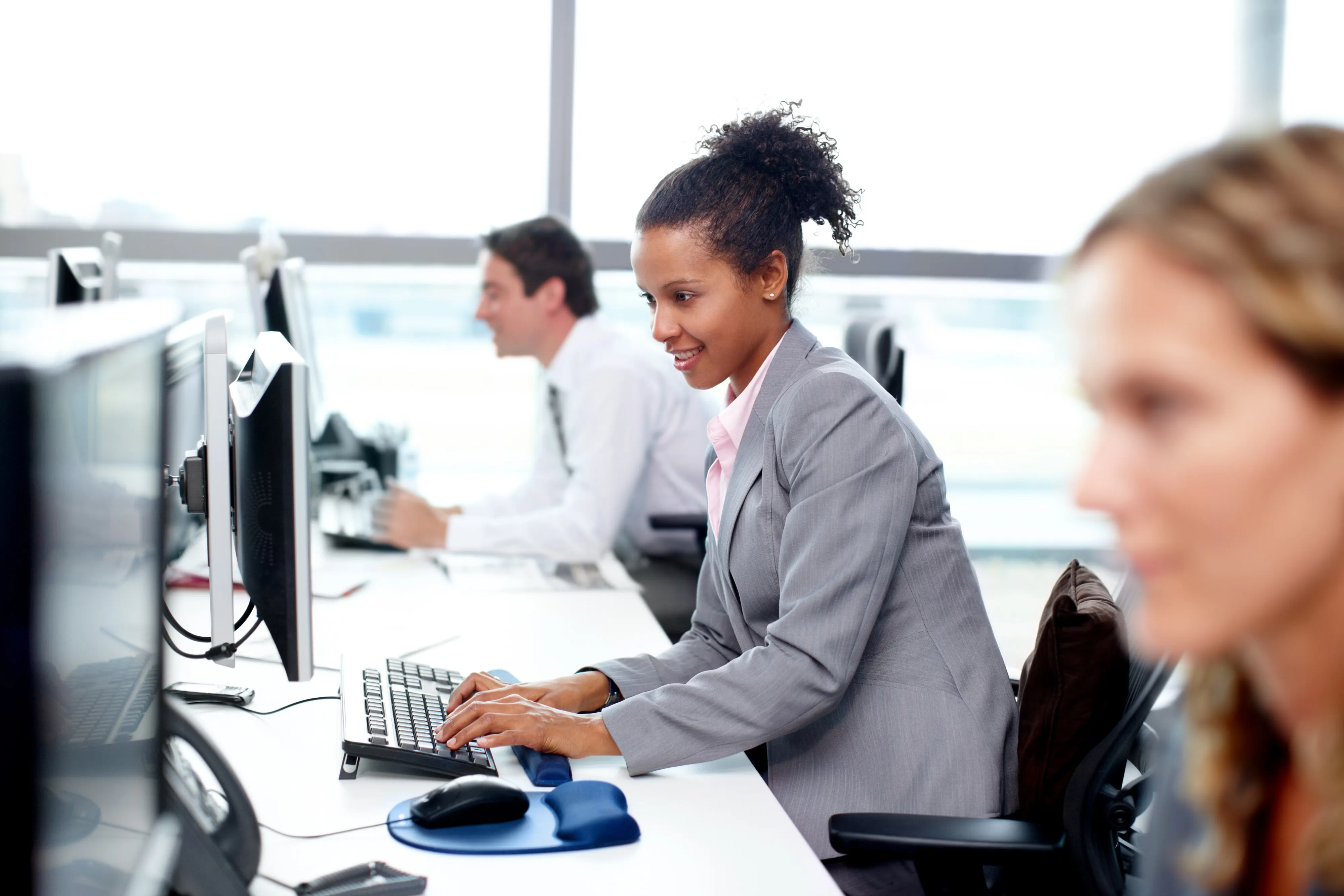 A professional working at her desk in a bright office