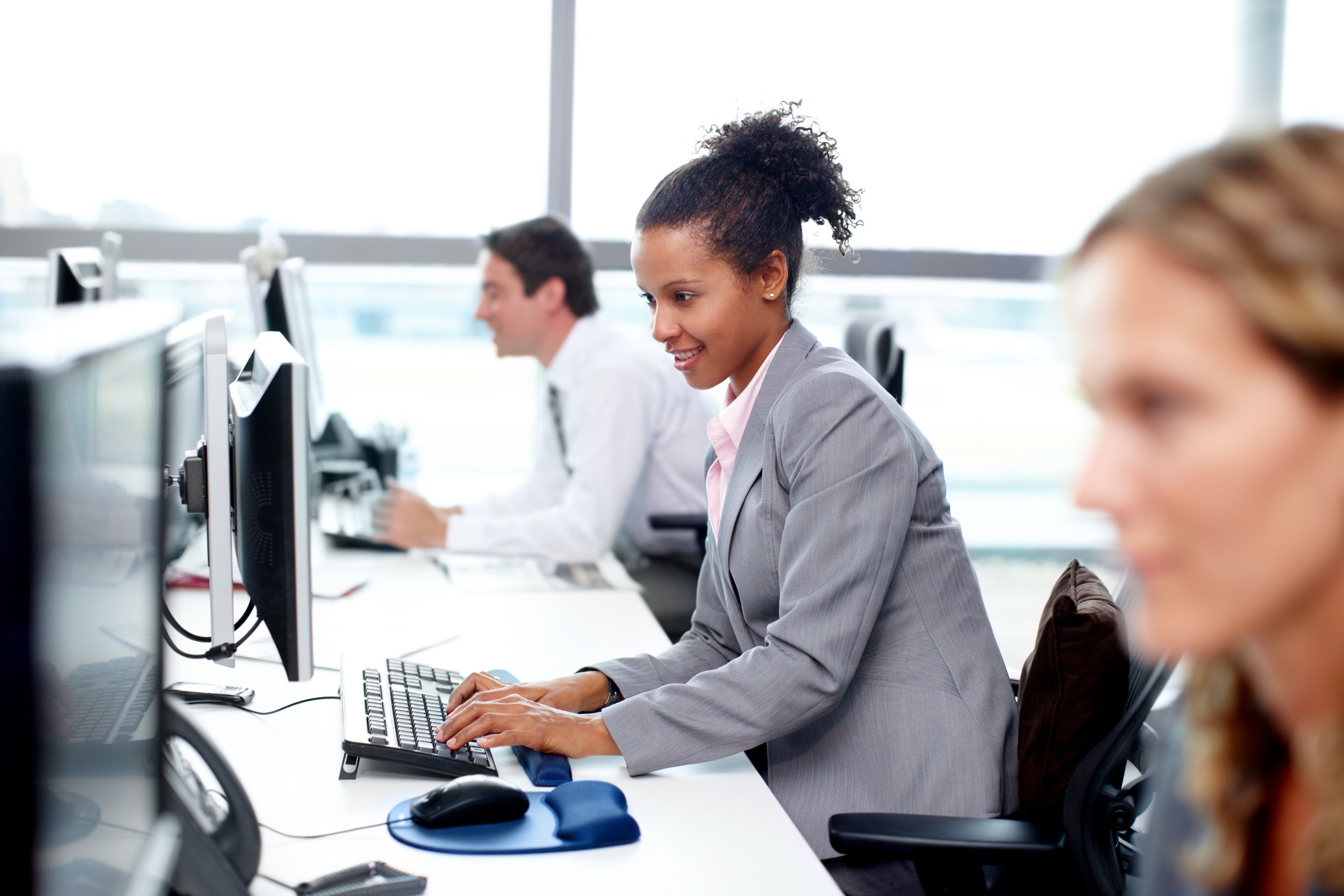 A professional working at her desk in a bright office